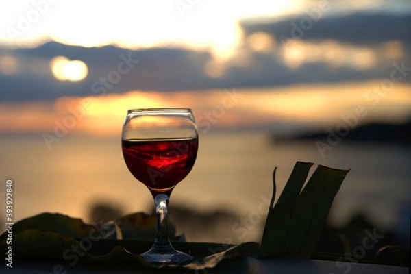 Fototapeta red wine in a glass at sunset,summer wine