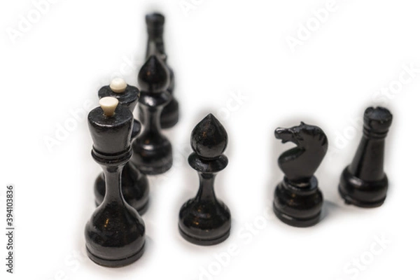 Obraz Wooden chess pieces. Black king and Queen surrounded by their large retinue, stand one behind the other, deployed in full face