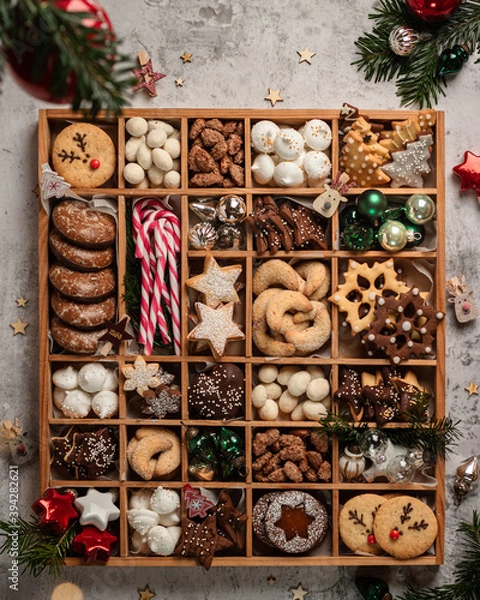 Fototapeta Christmas Cookies box with a lot of cookies, candies and christmas balls on white background