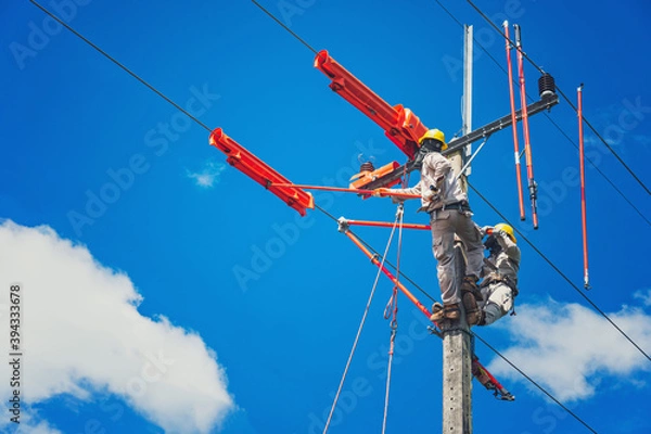 Fototapeta The lineman used tie stick to carve the tie wire used to wrap the electrical wires attached to the damaged high voltage insulator. In order to prepare to replace the damaged equipment
