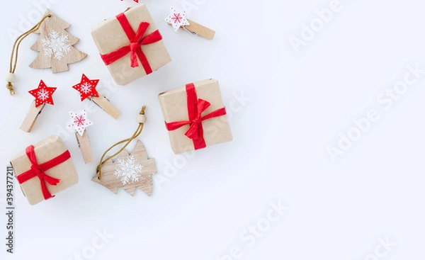Fototapeta Flat lay minimal composition with Christmas gift boxes and New Year decorations on white background with copy space.