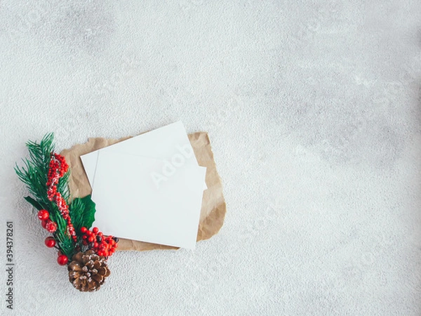 Fototapeta Blank card on white background with spruce branch. Flat lay composition with copy space.