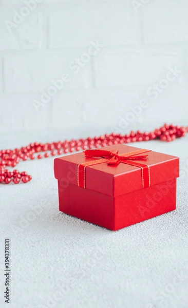 Fototapeta Red gift box on white minimalistic background