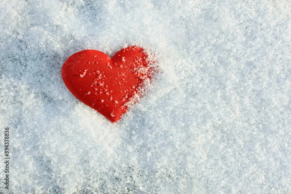 Fototapeta red heart lying on snow background in sunny winter day
