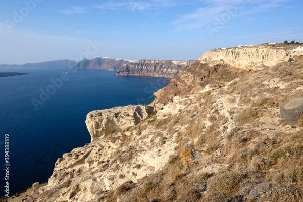 Fototapeta The coast of Santorini Island in Greece, impressive volcanic cliffs and a view of the caldera. Cyclades Islands