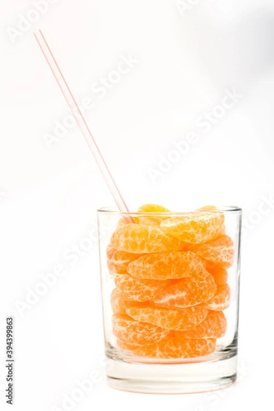 Obraz real natural orange juice with sliced in a glass. White background isolated.