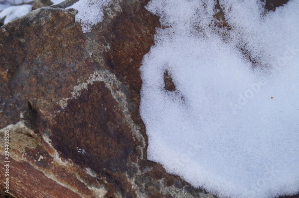Fototapeta Close-up (macro photography) natural stone with snow. Can be used as background
