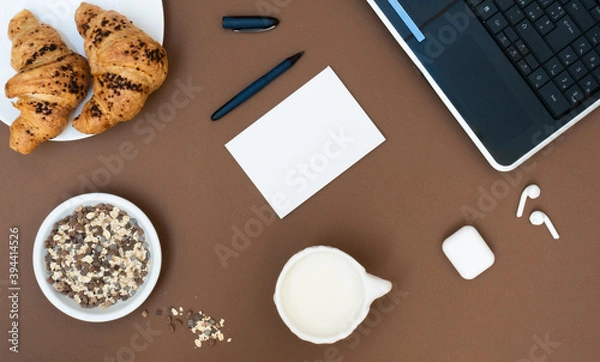 Fototapeta Business breakfast in office with coffee and croissant on white table background top view mock-up