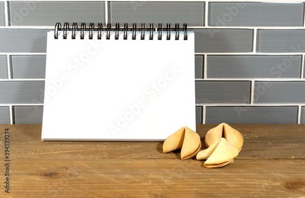 Fototapeta Blank spiral notepad in a modern kitchen with fortune cookies