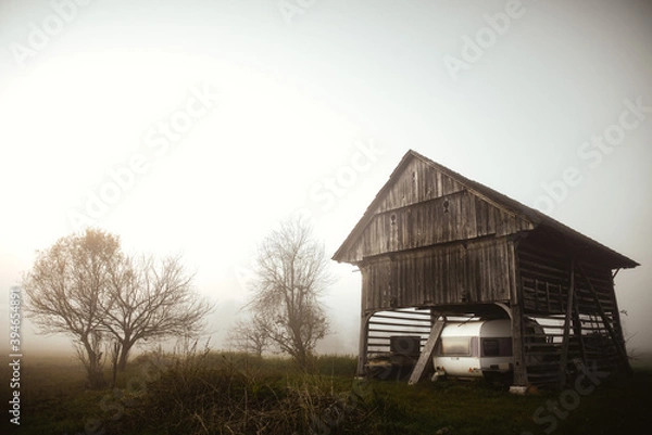Obraz Lonely barn in the evening mist