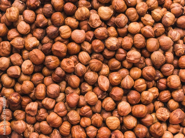 Obraz a lot of peeled hazelnuts without shells - food background
