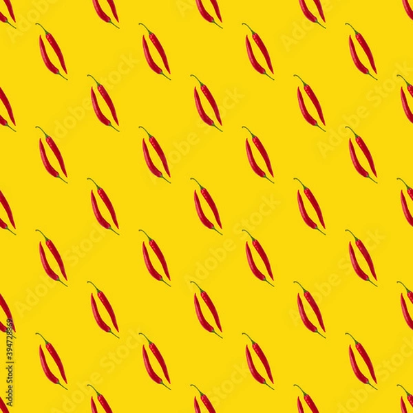 Fototapeta Seamless pattern made of isolated two red chili peppers on yellow background. Top view. Food flatlay.