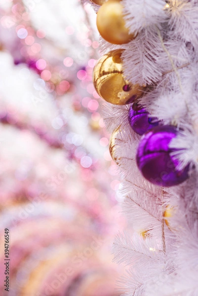 Obraz Christmas background of gold and purple balls and garlands, bokeh. Concept of greeting cards for New year, Christmas and thanksgiving. Vertical format, shallow depth of field
