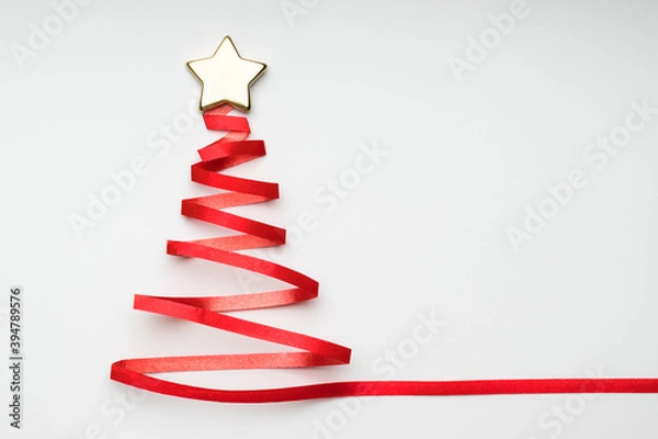 Fototapeta Christmas tree with golden star from red ribbon