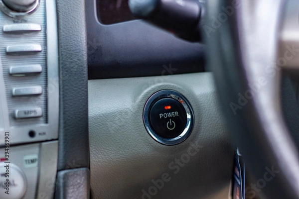 Fototapeta Close up engine car start button. Start stop engine modern new car button,Makes it easy to turn your auto mobile on and off. a key fob unique ,selective focus	