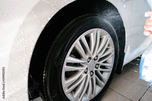 Fototapeta Car Wheels Cleaning with Special Stains and Oil Removing Detergent.