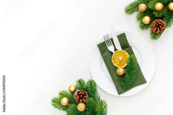 Fototapeta Christmas table setting with fir tree and gold toys on white background flat lay