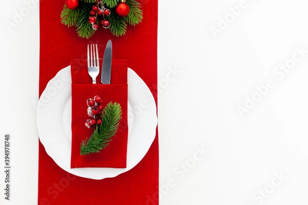 Obraz Table setting with spruce, plate, flatware on white background top view