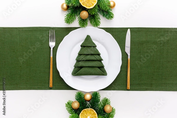 Obraz Christmas table setting with fir tree and gold toys on white background flat lay
