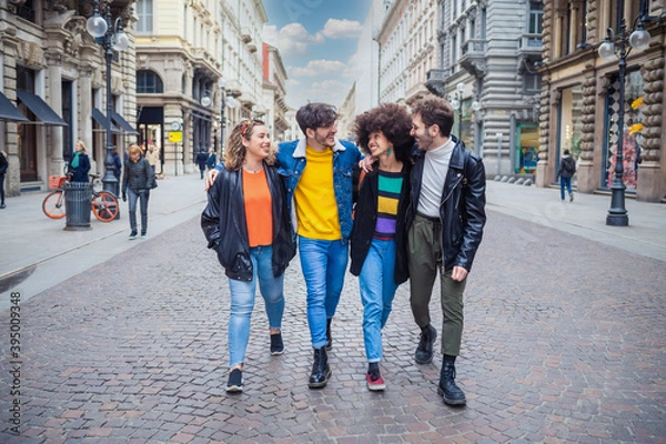 Fototapeta Group of friends schoolmate walking outdoors having fun hugging and enjoying time together