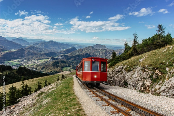 Fototapeta SCHAFBERGBAHN Cog Railway running from St. Wolfgang up the Schafberg, Austria.Journey to the top of Alps through lush fields and green forests.Beautiful mountain panorama.View of lake Wolfgangsee