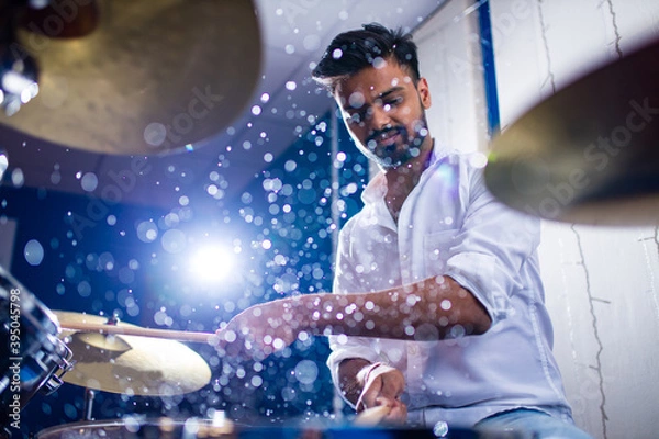 Fototapeta indian man playing the drums sticks close-up in recording studio