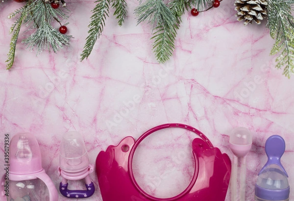 Fototapeta Children's accessories lie on pink marble and with Christmas tree branches. Place for text