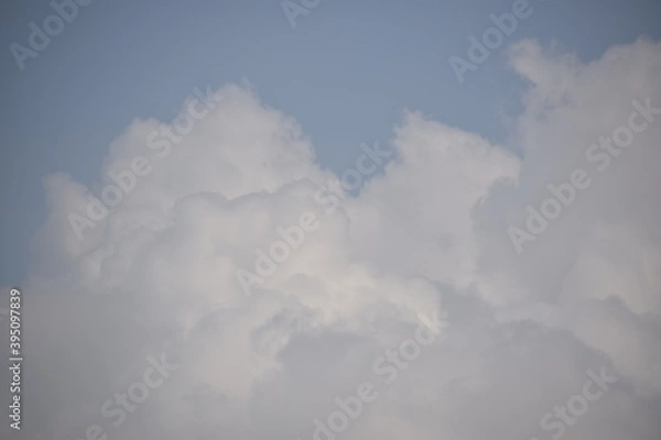 Obraz Blue sky with puffy white clouds.