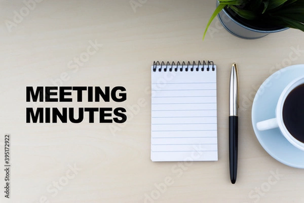 Obraz MEETING MINUTES text with fountain pen, notepad, and decorative flower on wooden background. Business and copy space concept..