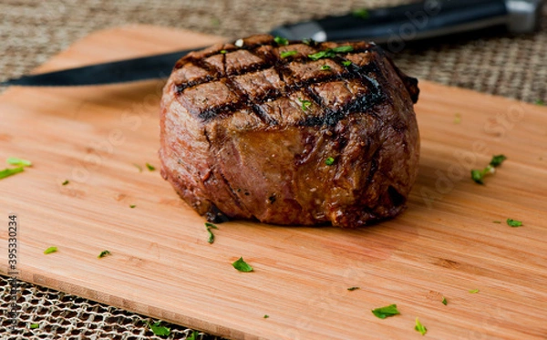 Fototapeta Steak and potatoes. Grade A grass fed angus beef steaks. Tenderloin, filet mignon, New York strip, bone in rib-eye grilled medium rare on outdoor wood-fired grill. Classic American steakhouse entree.