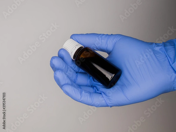 Obraz Blauer Handschuh mit Medikament 1