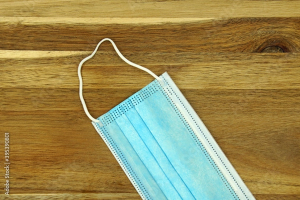 Obraz Blue mouth noose mask on a wooden table.