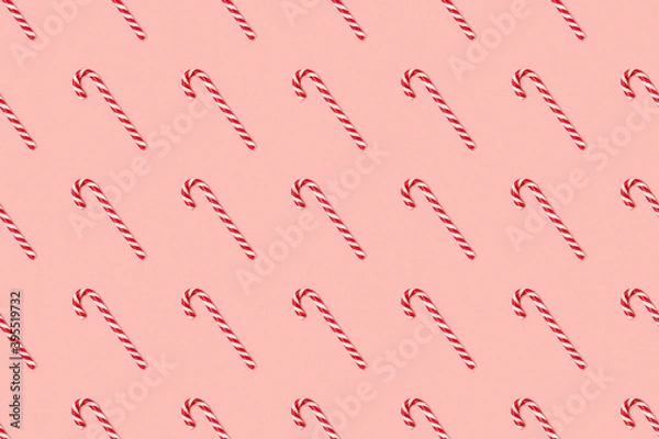 Obraz Christmas seamless pattern made of striped candy cane on a pink pastel background. Background made of food. Christmas and New year concept. Top view. Flat lay. Minimal composition