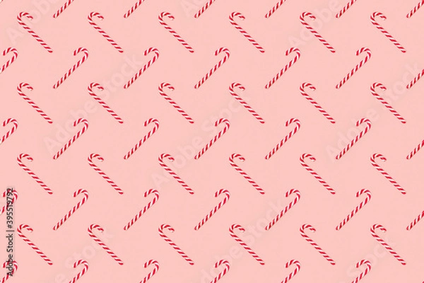 Obraz Christmas seamless pattern made of striped candy cane on a pink pastel background. Background made of food. Christmas and New year concept. Top view. Flat lay. Minimal composition