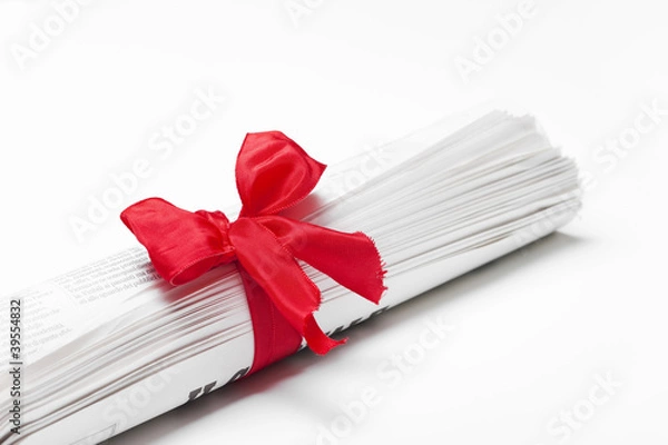 Obraz Newspaper on white background with red bow