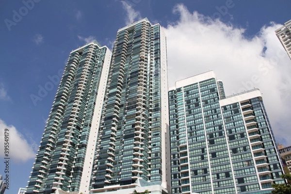 Fototapeta group of skyscrapers with blue sky background with clouds on a summer day