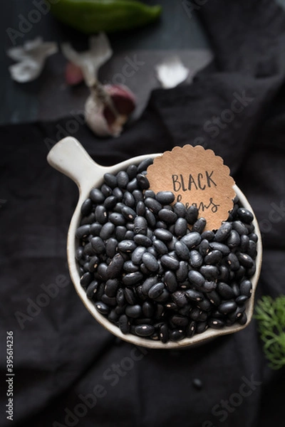 Obraz Closeup view of a white bowl full of black beans.