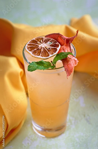 Fototapeta carrot lemon mixed juice drink Fresh cocktail on light stone background. Summer drinks and cocktails
