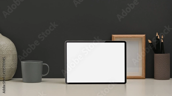 Fototapeta Worktable with tablet, stationery and decorations in home office room