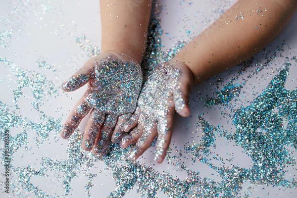 Obraz small children's hands in glitter sequins . Christmas new year holidays.