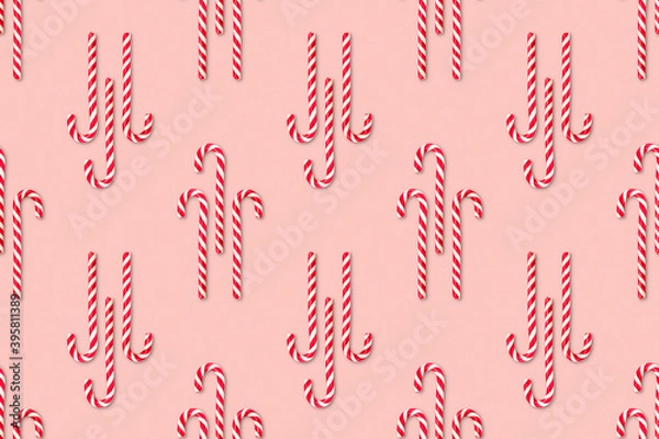 Obraz Christmas seamless pattern made of striped candy cane on a pink pastel background. Background made of food. Christmas and New year concept. Top view. Flat lay. Minimal composition