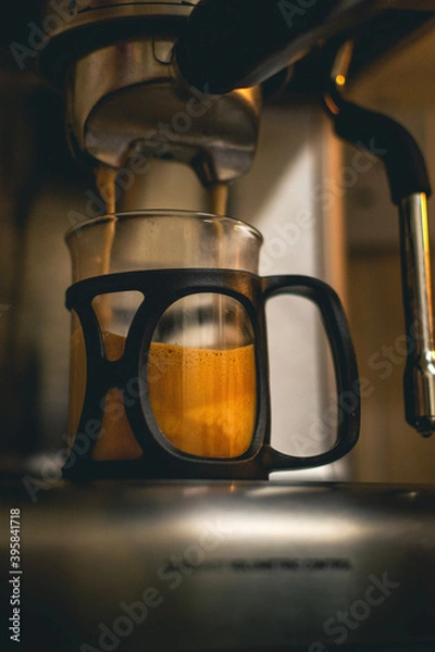 Obraz coffee machine making a coffee into glass cup 