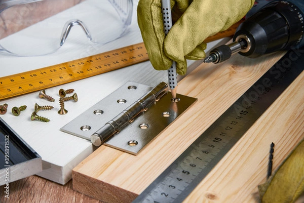 Fototapeta Installation of furniture hinges in the chipboard, tools and accessories needed to perform the work. Small carpentry work at home, the concept of a home master, self-repair of the house
