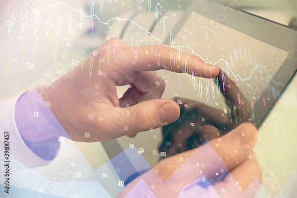Fototapeta Multi exposure of man's hands holding and using a phone and financial chart drawing. Market analysis concept.
