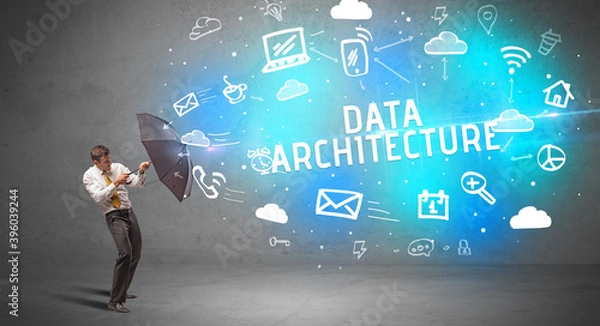 Fototapeta Businessman defending with umbrella from DATA ARCHITECTURE inscription, modern technology concept