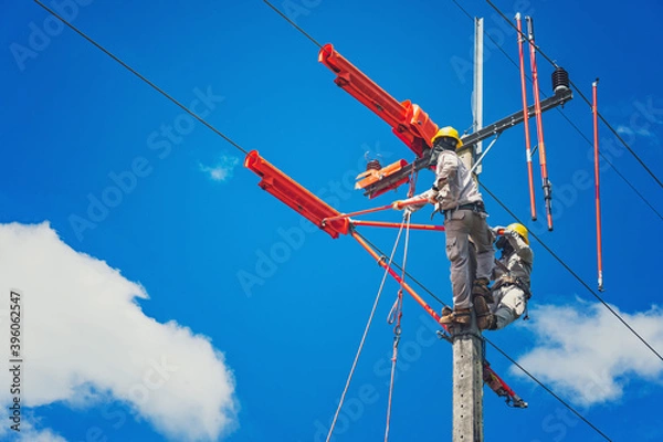 Fototapeta The lineman used tie stick to carve the tie wire used to wrap the electrical wires attached to the damaged high voltage insulator. In order to prepare to replace the damaged equipment