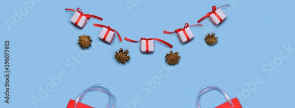 Fototapeta  Flatlay Christmas sales and fairs. Paper bags for shopping and gift wrappers, alternating with golden cones.