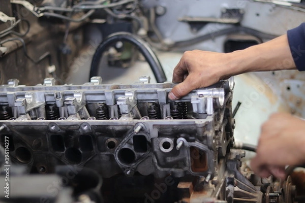Fototapeta The mechanic is checking the engine.