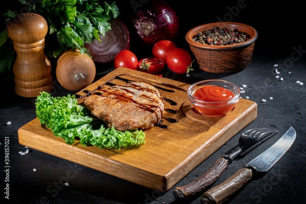 Fototapeta Grilled ribeye beef steak, herbs and spices on dark background