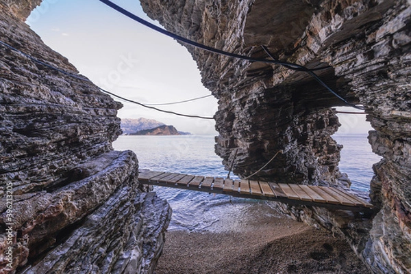 Fototapeta Wooden bridge, part of footpath fort tourist from Old Town to small bay with Mogren Beach in Budva, Montenegro